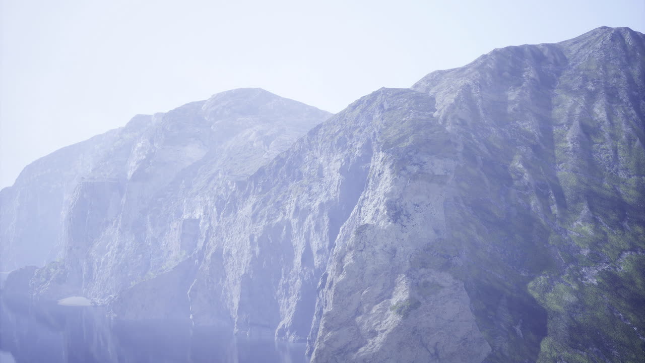 Majestic mountains enveloped in mist during early morning hours