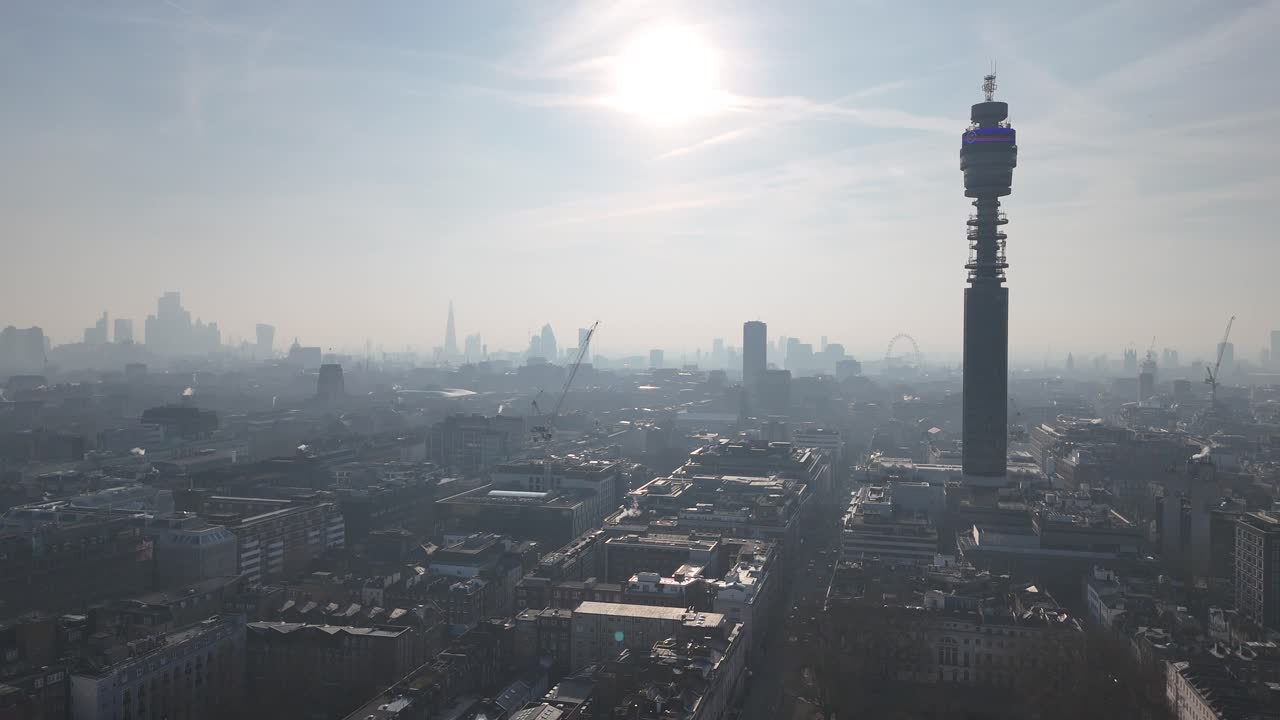 London skyline and BT tower silhouetted against Low misty rising sun aerial view