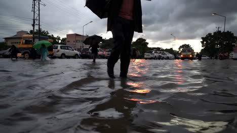 people walking through flooded streets