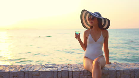 Lone-asian-woman-with-hat-and-exotic-cocktail