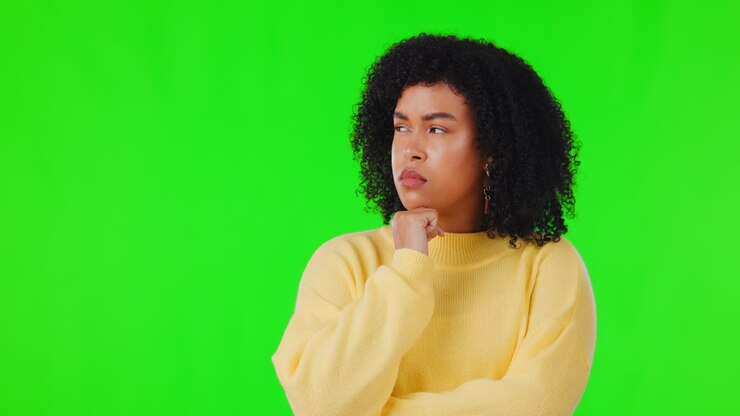 Woman, thinking and face on studio green screen