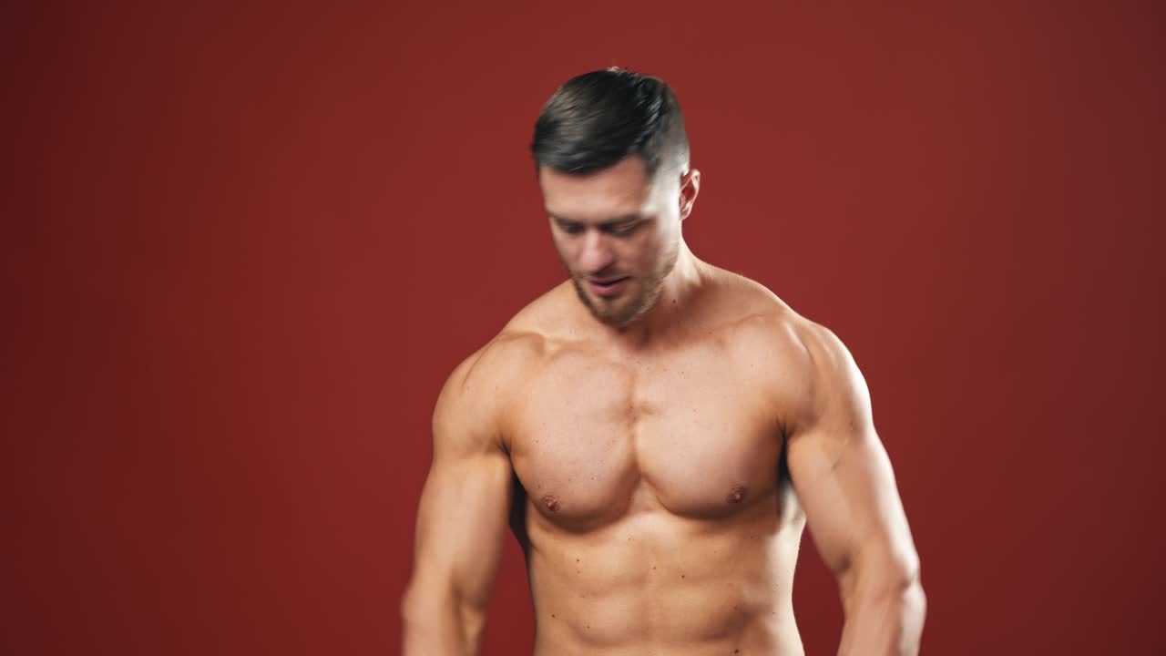 Strong And Muscular Athletic Man. Fashion portrait of strong brutal man training in studio