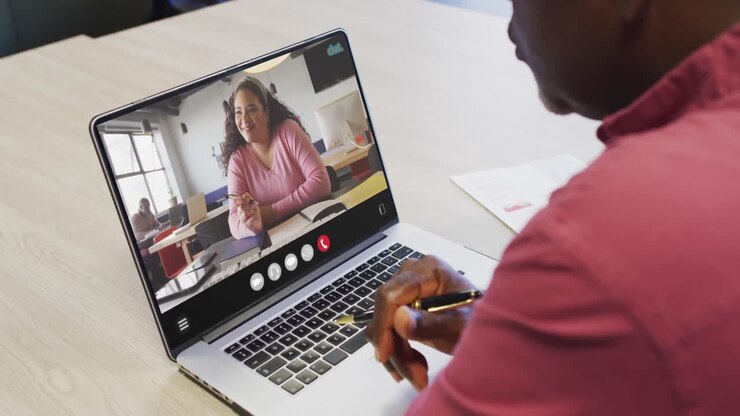 African american man using laptop for video call, with business colleague on screen