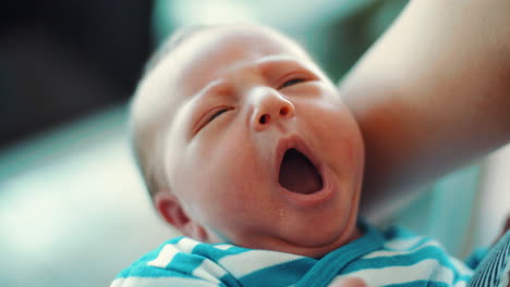 newborn baby in the arms of his mother