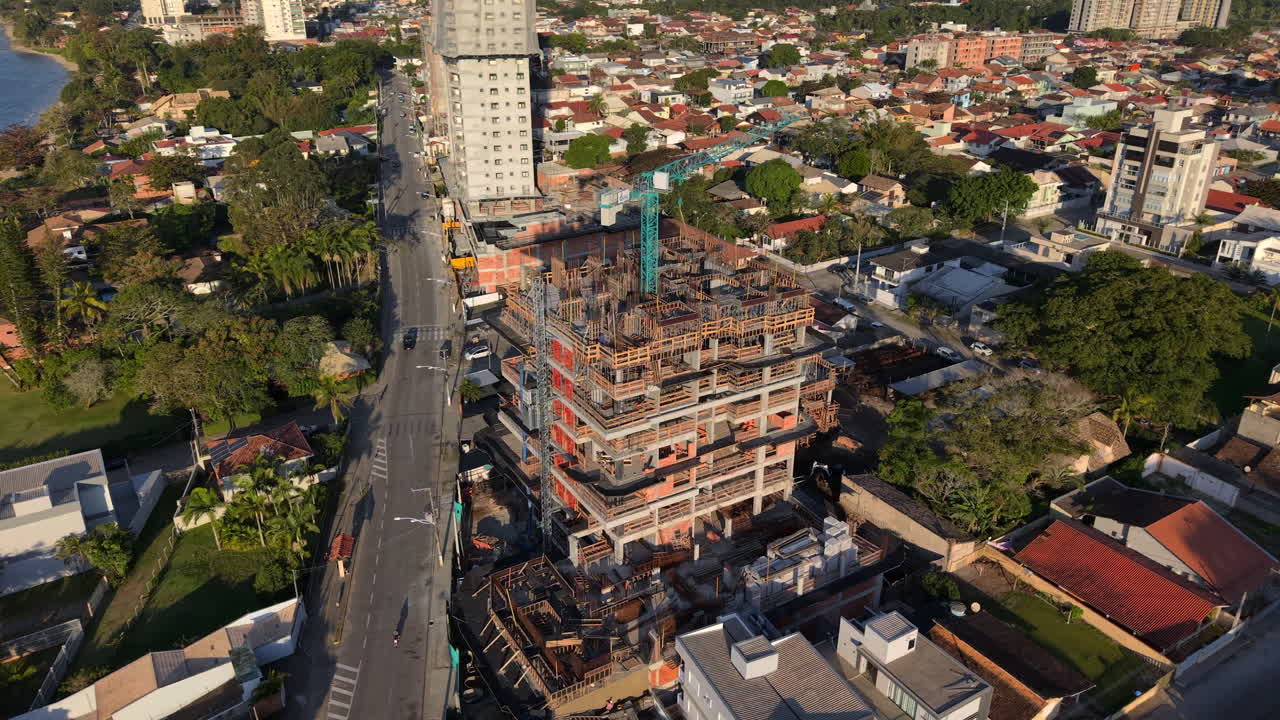 Aerial view of skyscraper under construction with big crane on top. Penha, Brazil