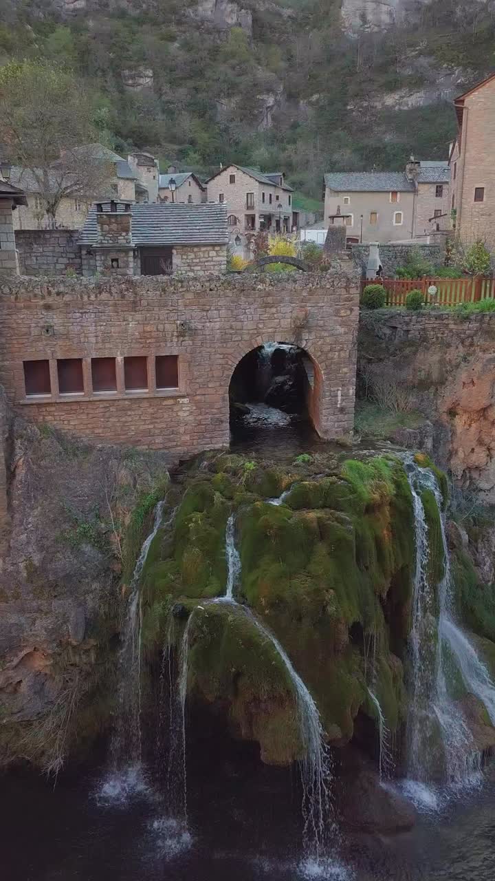 Aerial vertical shot above Saint Chély du Tarn around the waterfall during the day, Lozere departement, Occitanie region, France