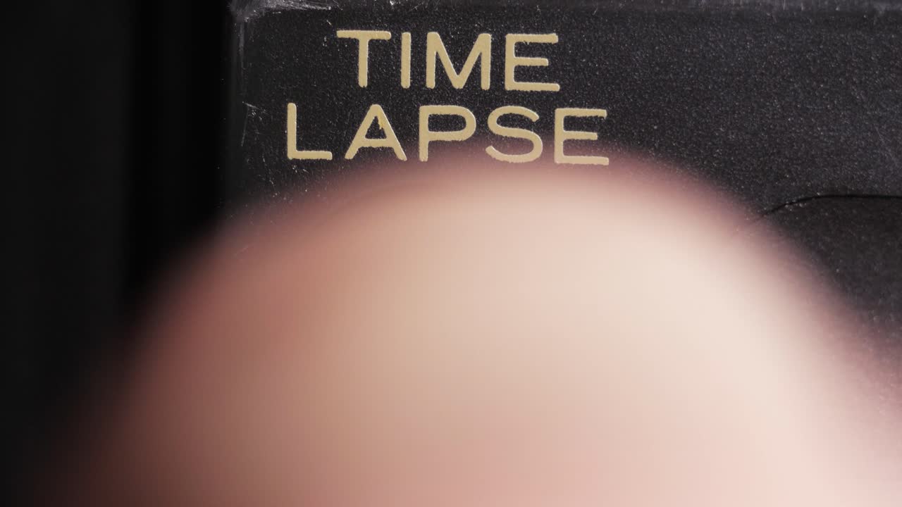 Macro close up of finger pressing time lapse button for fast motion capture or editing effect