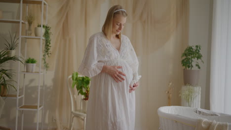 pregnant woman caressing belly portrait