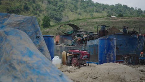 abandoned boat with generator on river bank