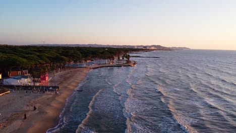 aerial above beautiful coastline of durres in albania during sunset.
