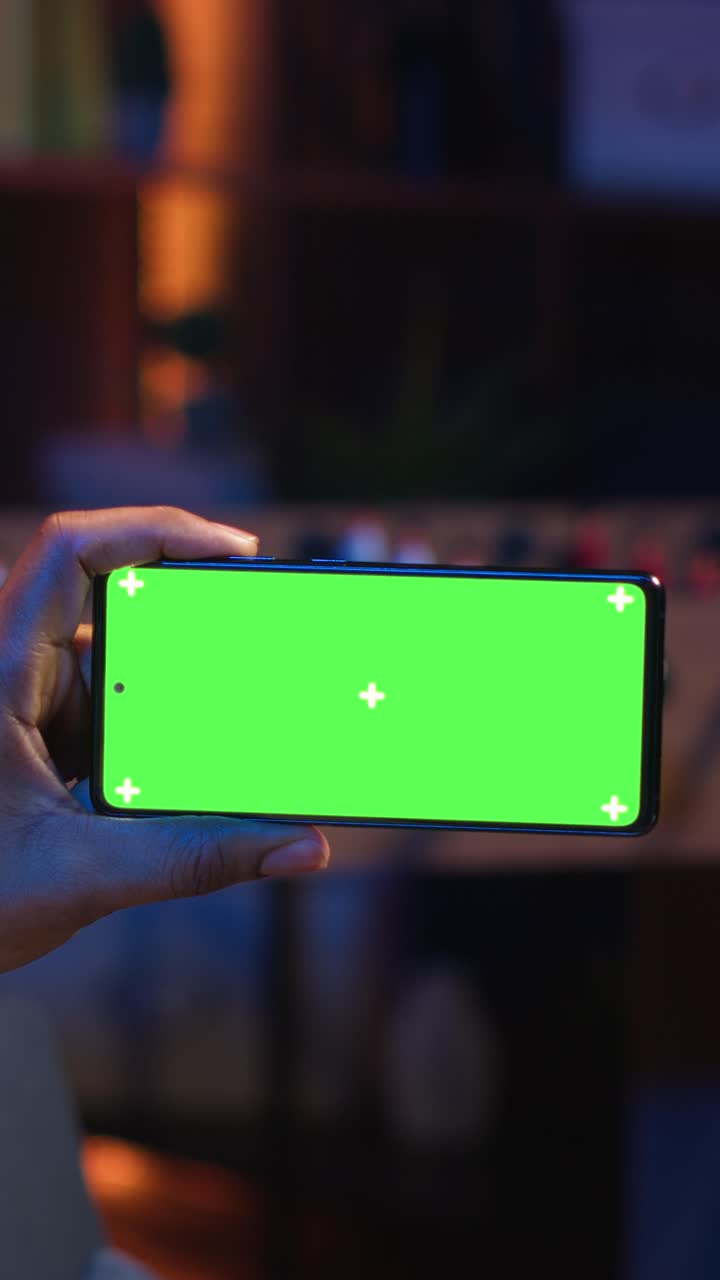 Vertical Video Black freelancer uses green screen mockup on tablet to work in the living room