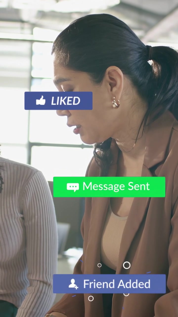 Vertical video: Right woman reacting to sliding notifs while arranging marketing charts on tablet
