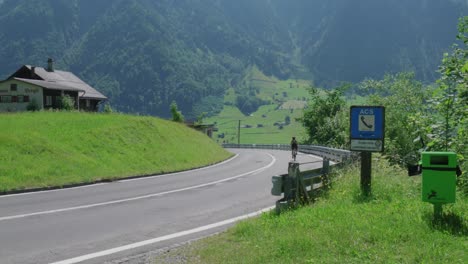 biking along a road on mountain with scenic view of valley