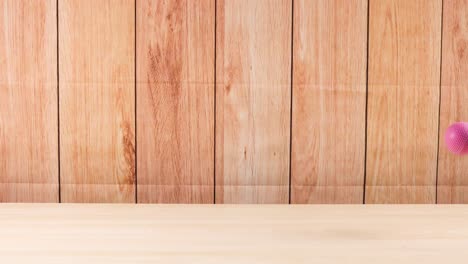 a ball bounces on a wooden floor