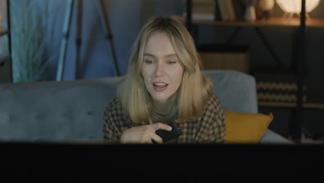 young woman relaxing on couch watching tv