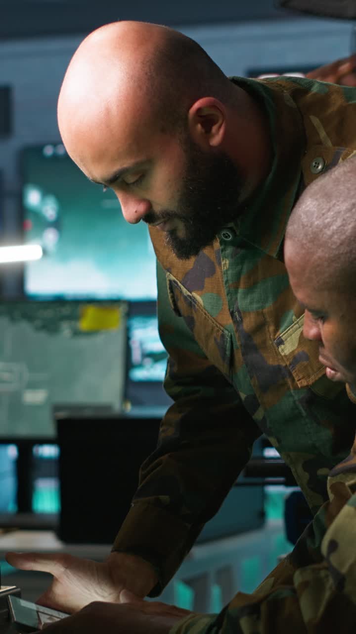 Vertical video Military dispatcher helped by coworker with tablet