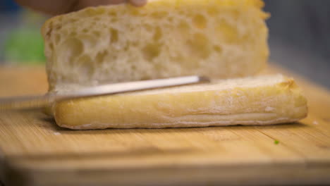 cutting and opening a loaf of bread