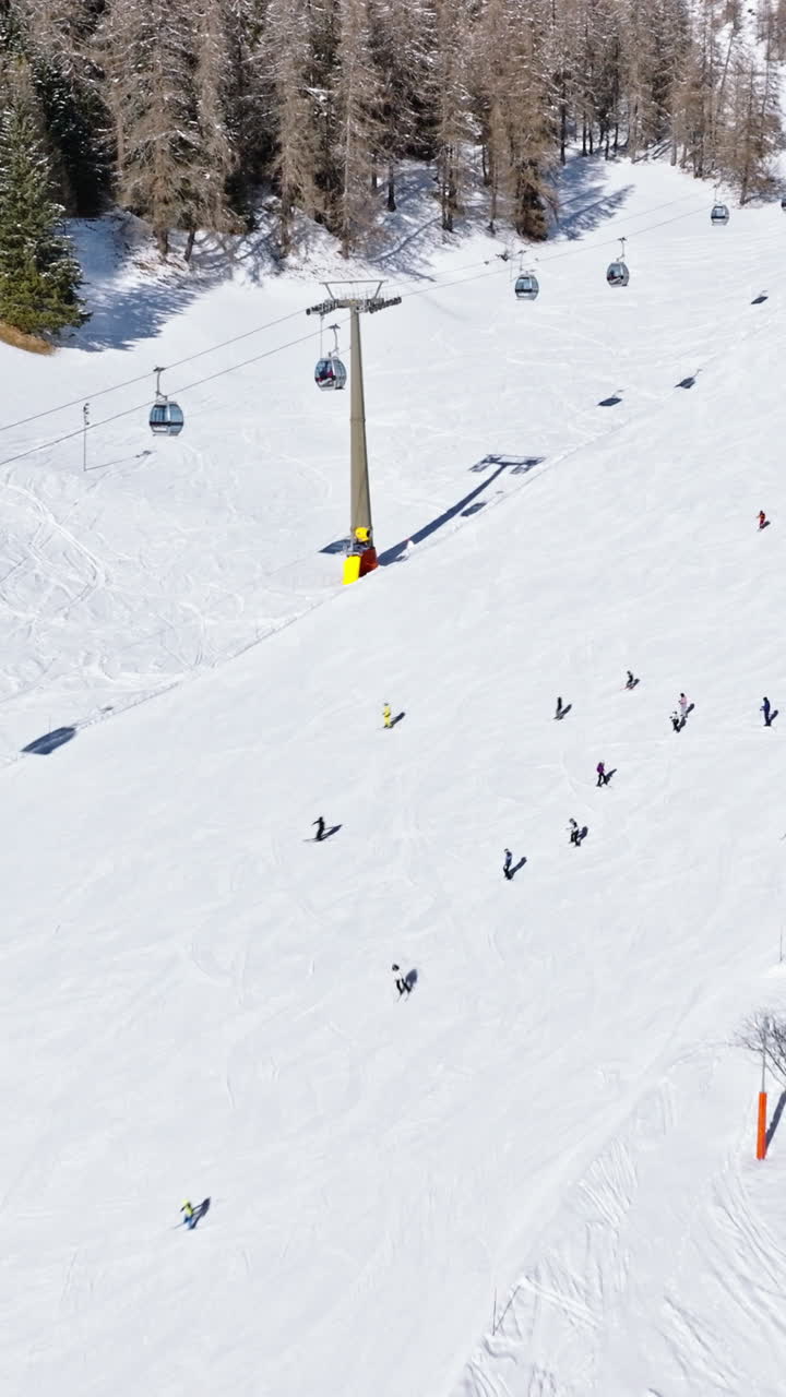 Aerial drone view of the Colfosco ski resort in South Tyrol, Dolomites, Northern Italy. Vertical