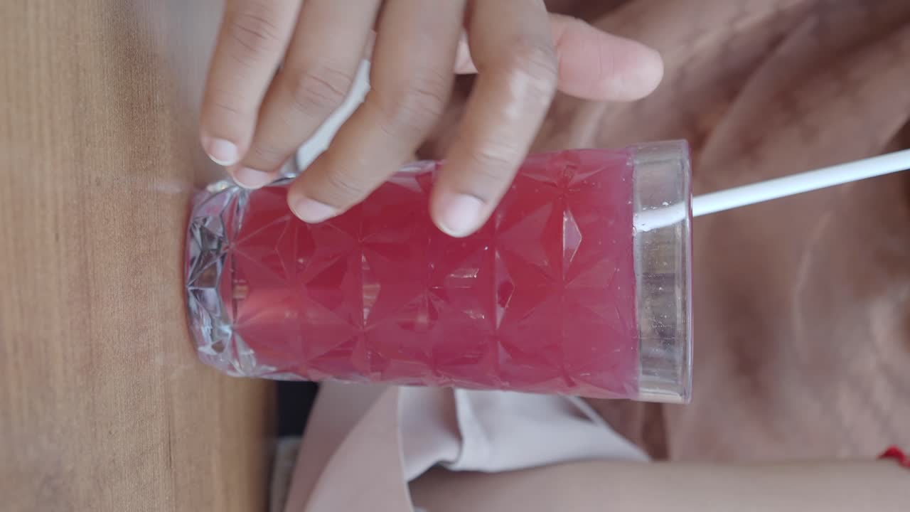 Woman enjoying a red juice drink