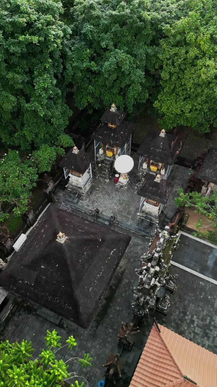 Sacred temple in Ubud Bali featuring shrines with traditional Balinese architecture, cultural details, and spiritual artistry set among lush trees reflecting timeless heritage and religious devotion
