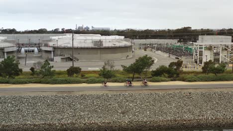 4k-aerial-drone-shot-of-a-pack-of-bicycle-riders-out-for-a-morning-ride-on-the-way-to-the-beach