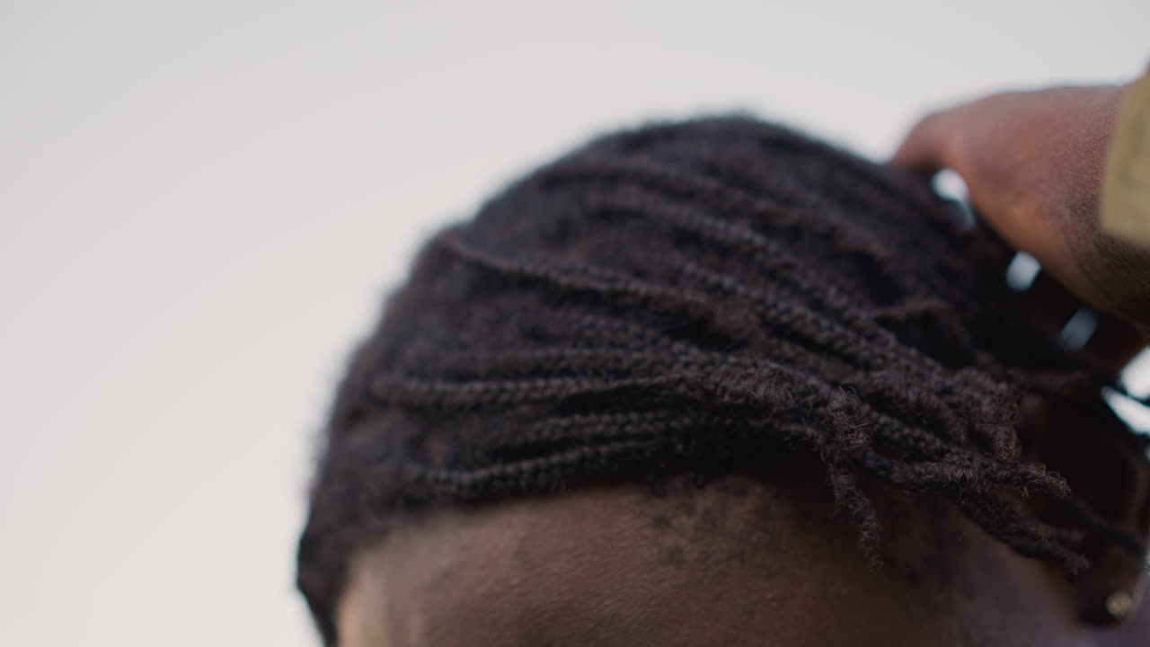 Black Soldier Receiving Hair Adjustment CloseUp, Camouflage Sleeve Gently Checking Dreadlocks And Roots, Solemn Preparation For Ceremony And Homecoming, Moment Of Respect And Teamwork