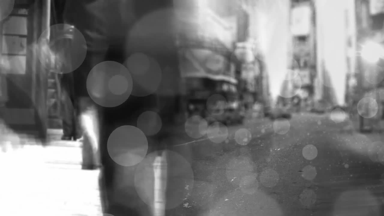 Animation of glowing blurred lights and spots over cityscape