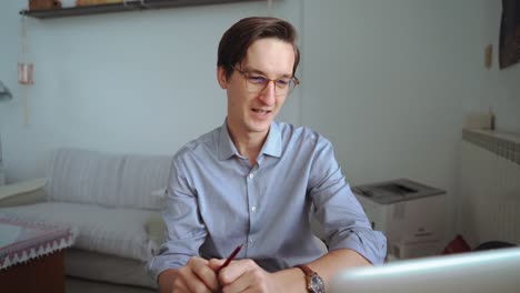 male entrepreneur talking on video chat via laptop