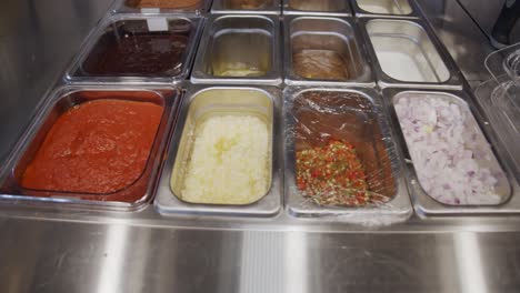 food ingredients inside metal storage tray on restaurant kitchen table