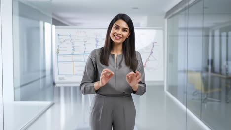 professional woman presenting in a modern office
