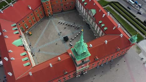 aerial view overlooking the royal castle in old town, warsaw, poland - tilt, drone shot