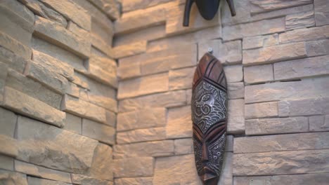 wooden african mask on the living room wall