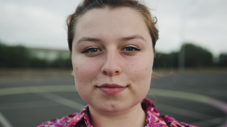 Happy teenager looking at camera outdoor