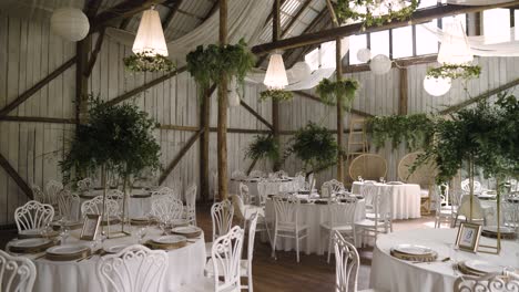 boho vintage wedding hall with stunning white lighters and green plants
