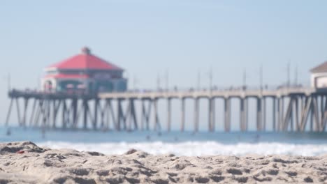 retro huntington pier, surfing in ocean waves and beach, california coast, usa.