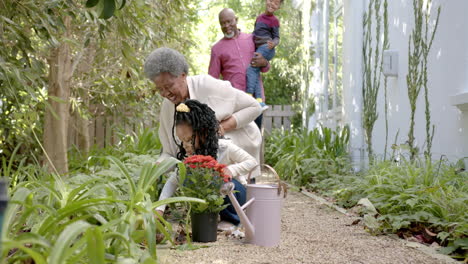 Happy-african-american-grandparents-and-grandchildren-in-sunny-garden,-copy-space,-slow-motion