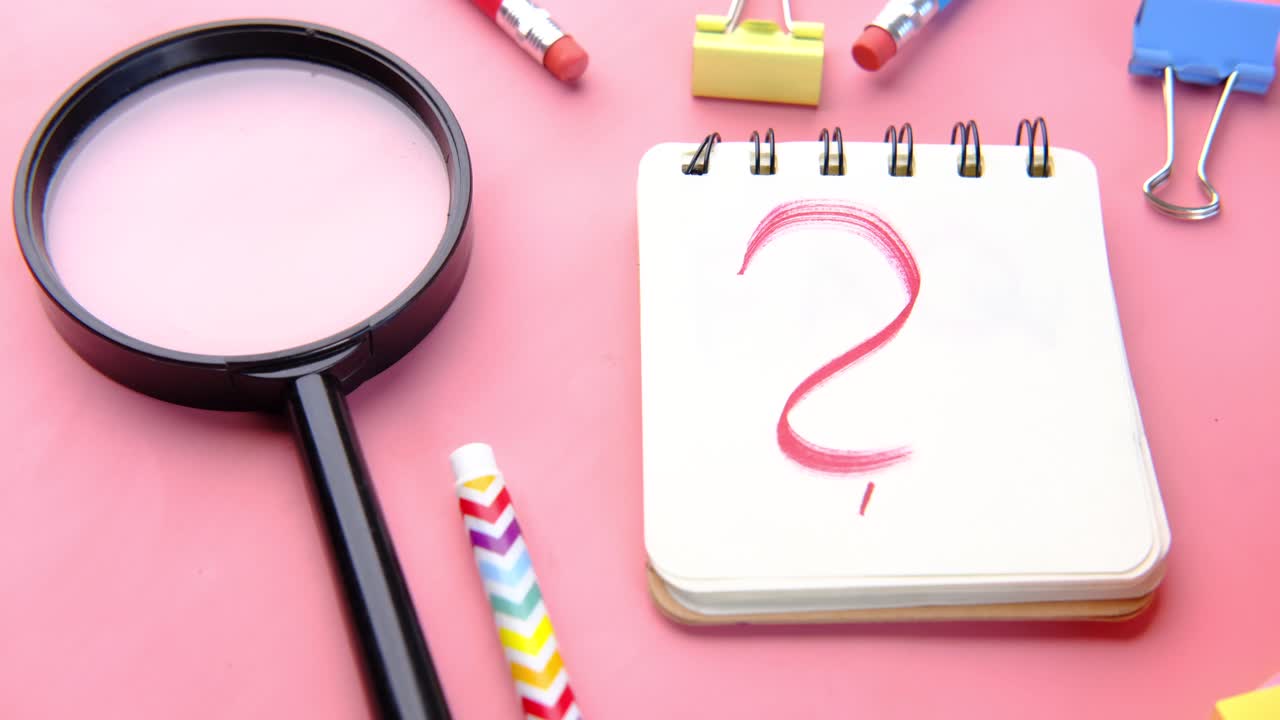 signo de pregunta en un cuaderno con suministros escolares