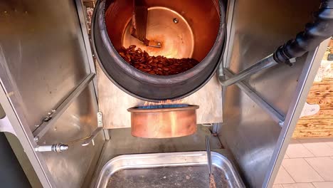 almonds being roasted in a rotating drum