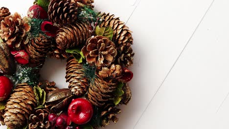 christmas wreath on white wooden background