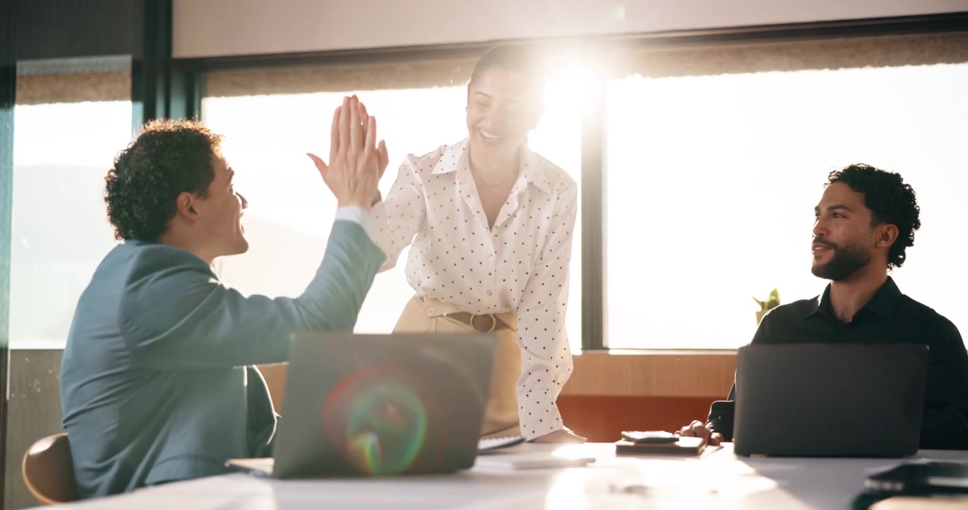Business Team Celebrating Success with High Five in Office