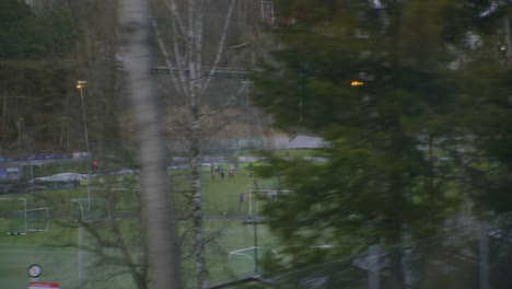 school soccer fields seen from train to oslo vinterpark, grakammen, sentrum city centre