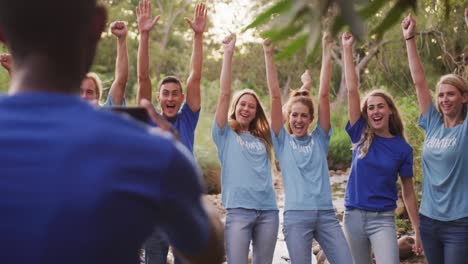 Mid-adults-volunteering-and-putting-arms-in-the-air-during-river-clean-up-day