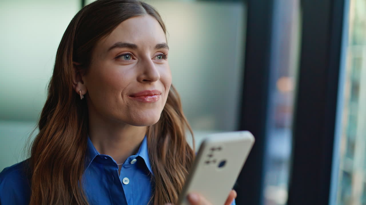 Brunette shopping online smartphone at light apartment closeup. Smiling woman
