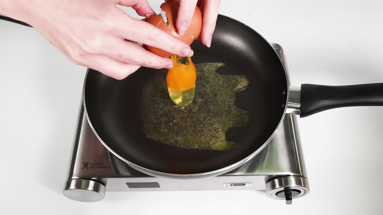 Sequential frames showing an egg being fried