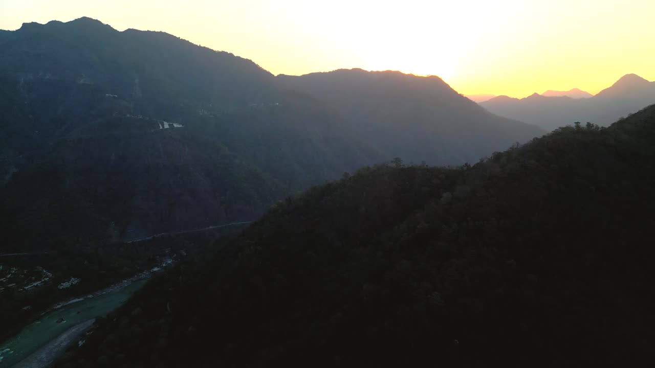 beautiful sunrise behind the mountains and Ganga river flowing in Rishikesh done moving closer to sun view in india