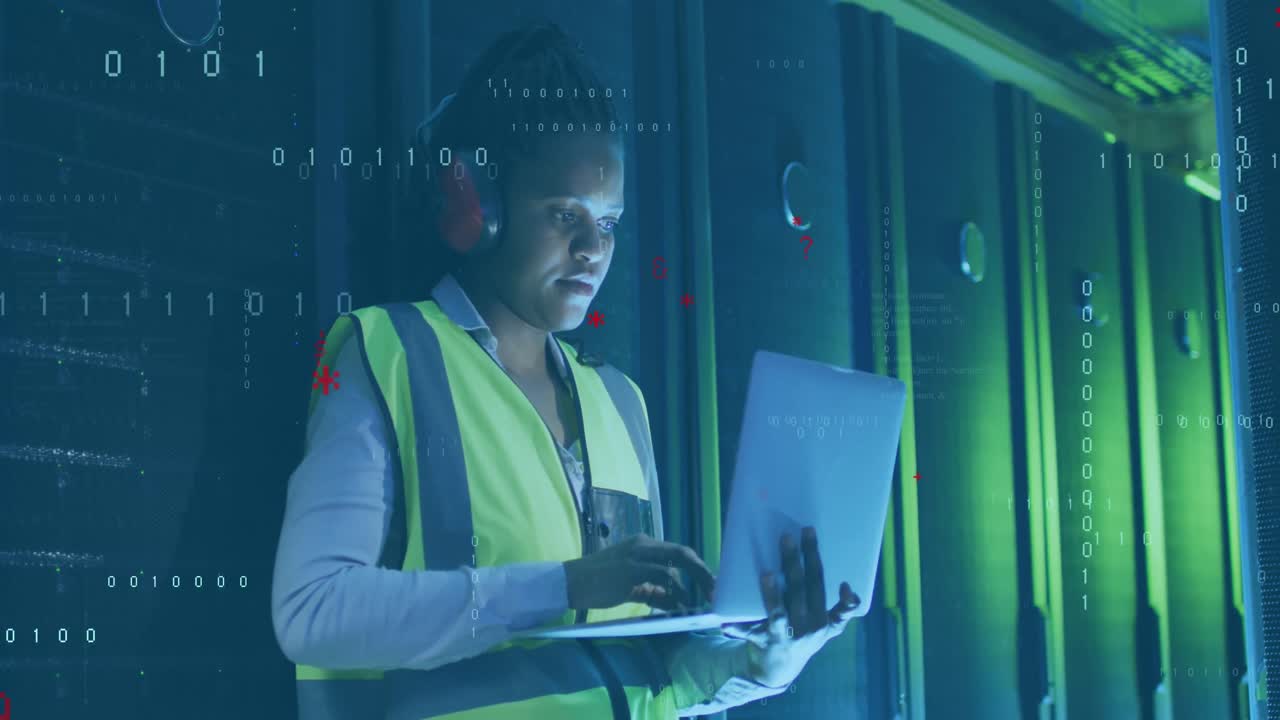 Animation of computer language, african american female engineer using laptop in server room