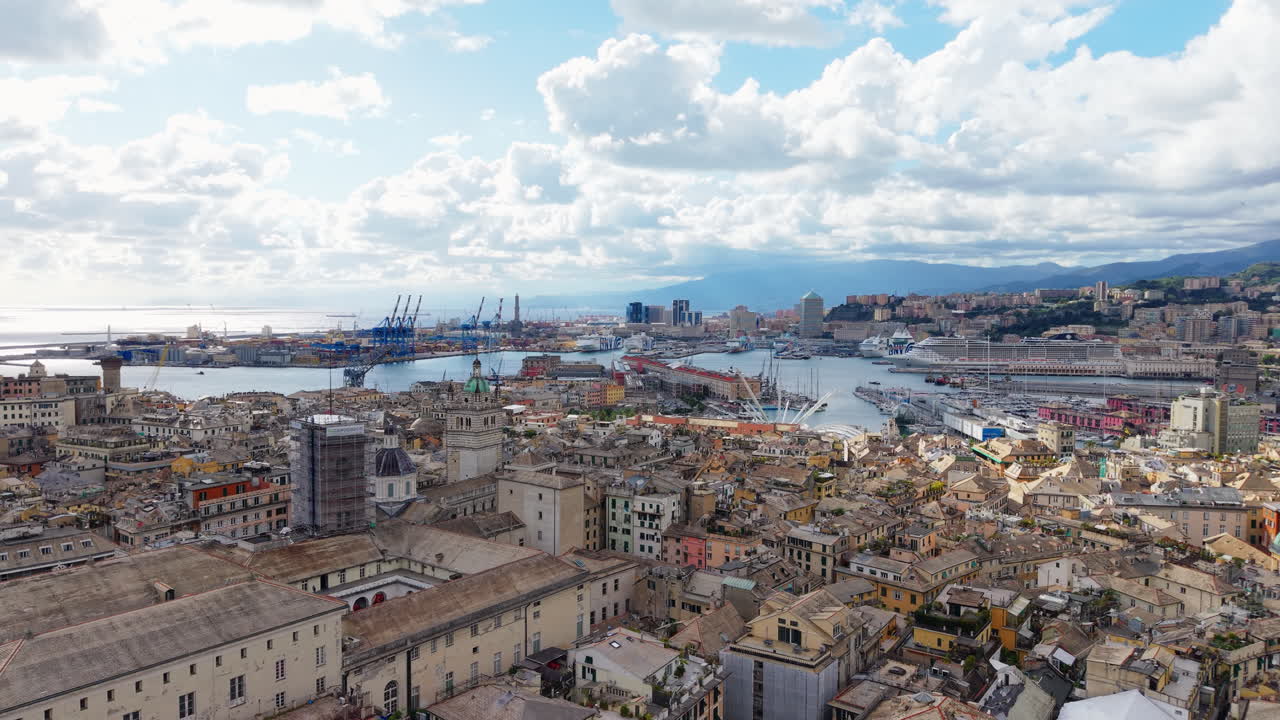 Drone panning shot over Genoa historic center with birds flying above port and colorful rooftops