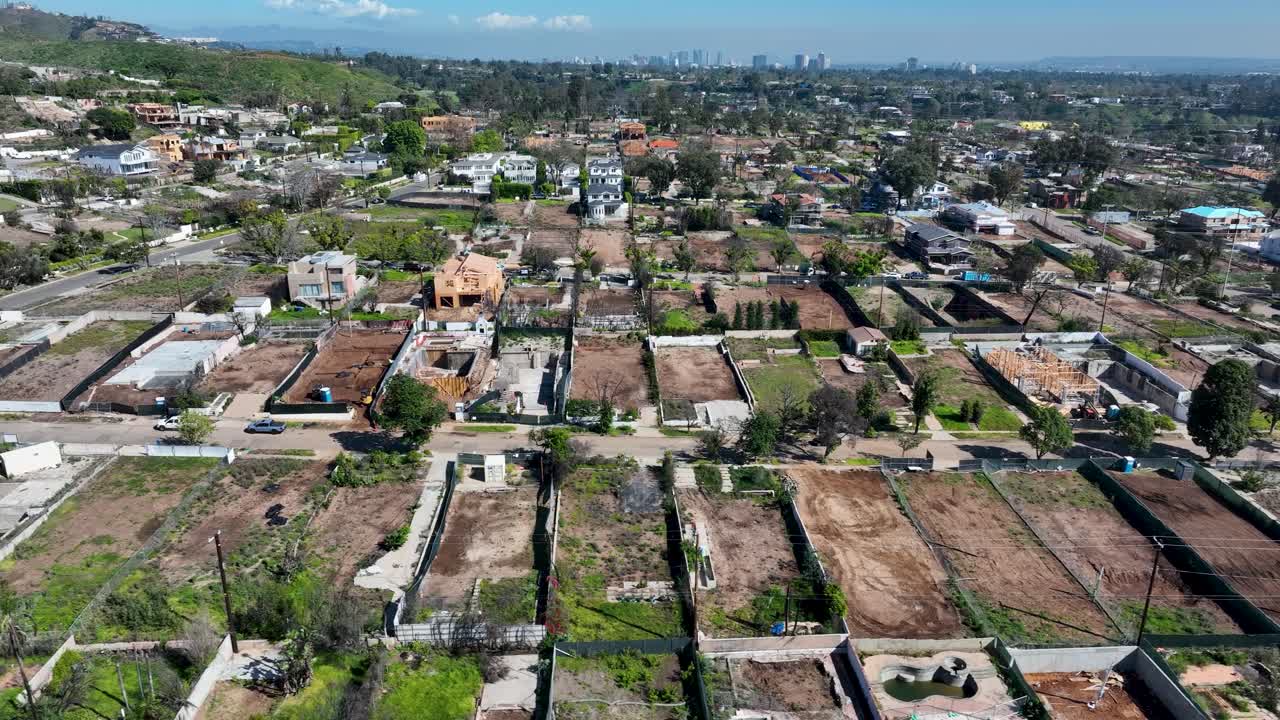 Aerial view of completely burned residential area showing wildfire destruction and charred properties in Palisades
