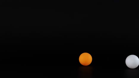 colorful balls, including orange, pink, and white, are arranged dynamically against a dark background.
