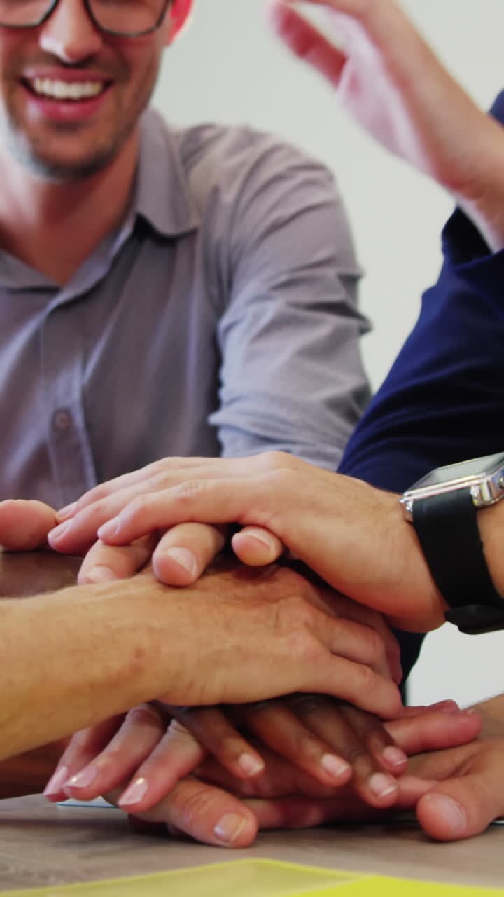 Businesspeople forming hands stack